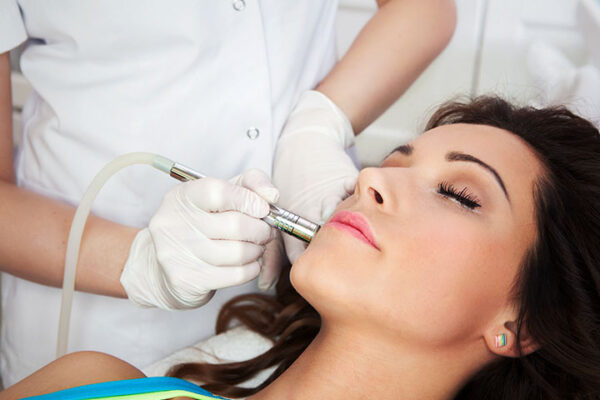 Close-up Of Woman Getting Facial Hydro Microdermabrasion Peeling Treatment At Cosmetic Beauty Spa Clinic