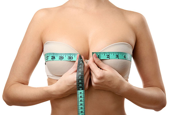 A woman measuring her bust size